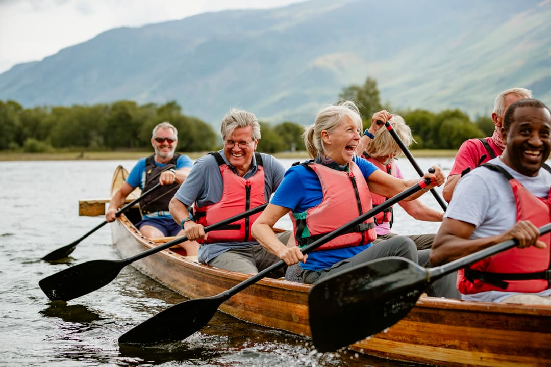 A senior group of friends enjoying rowing on the River Derwent.